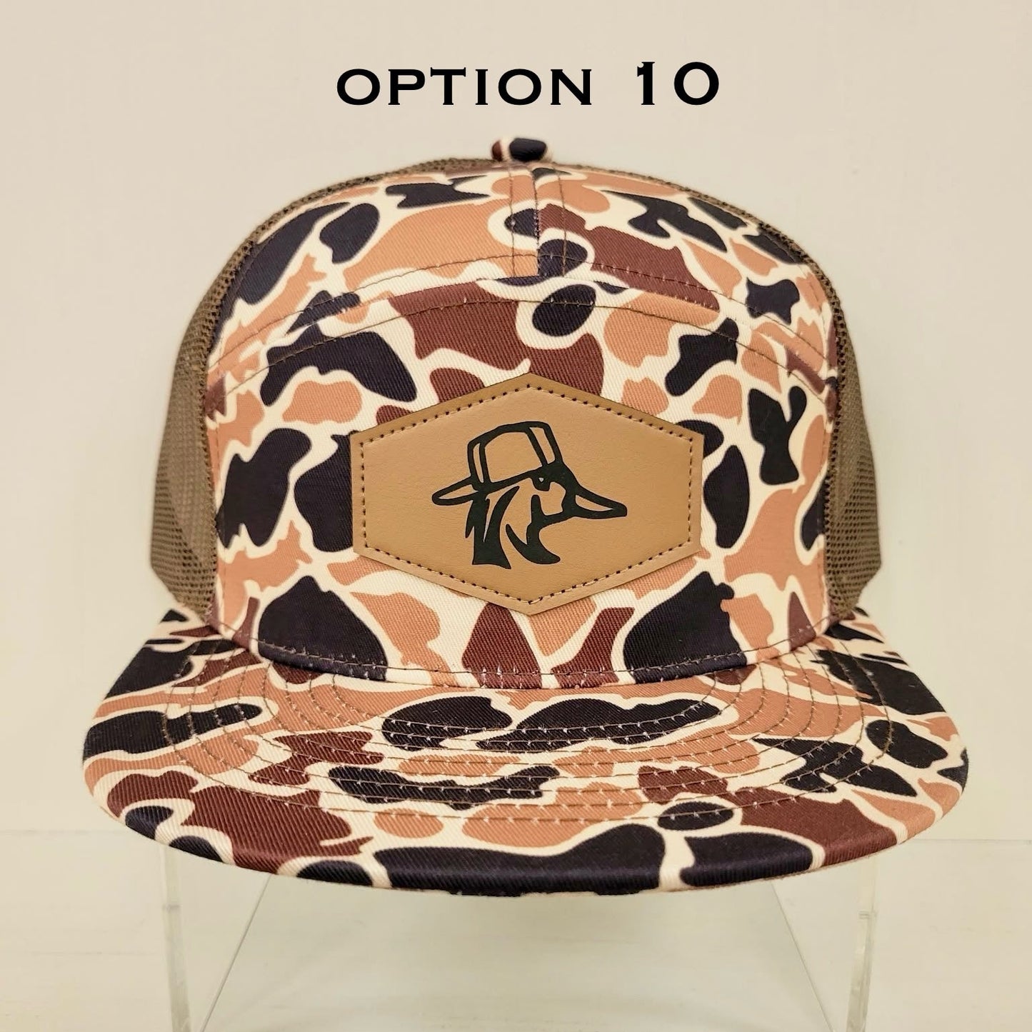 Camouflage-patterned cap with a brand logo on a beige background