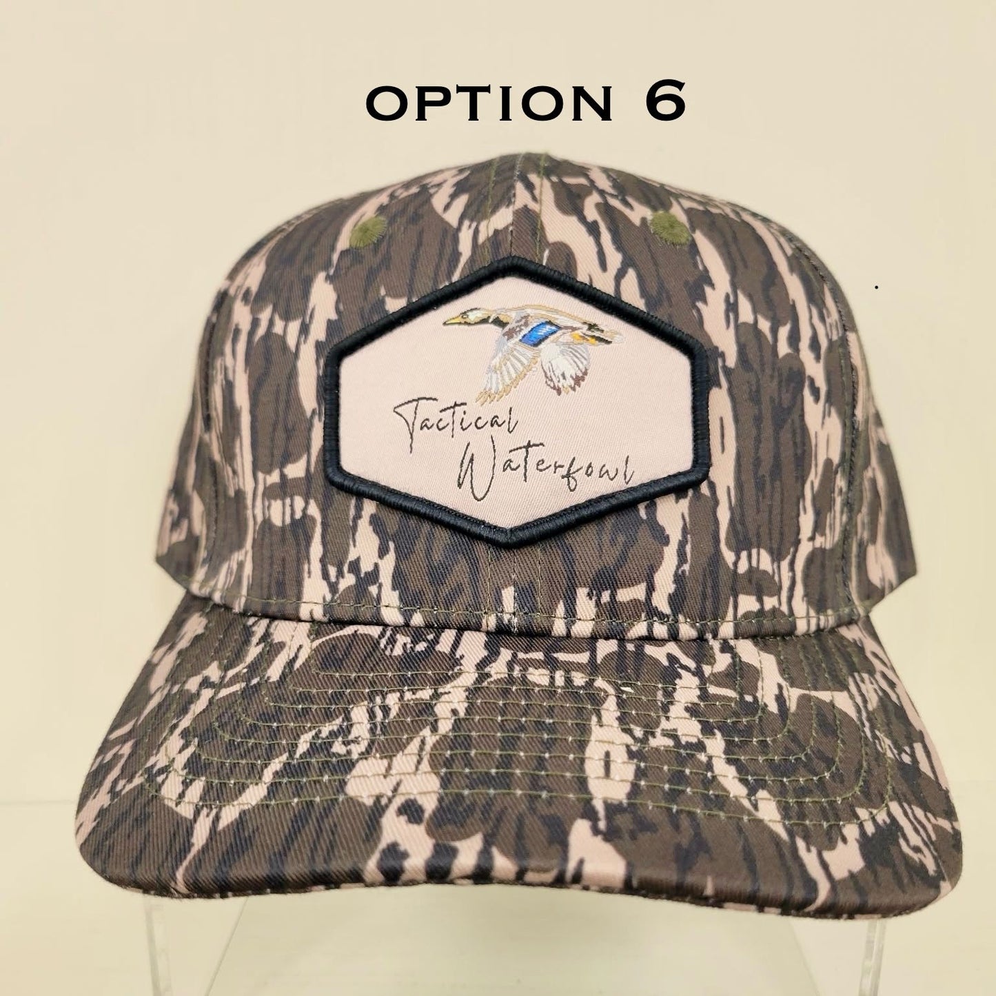 Camouflage cap with a brand logo on a beige background
