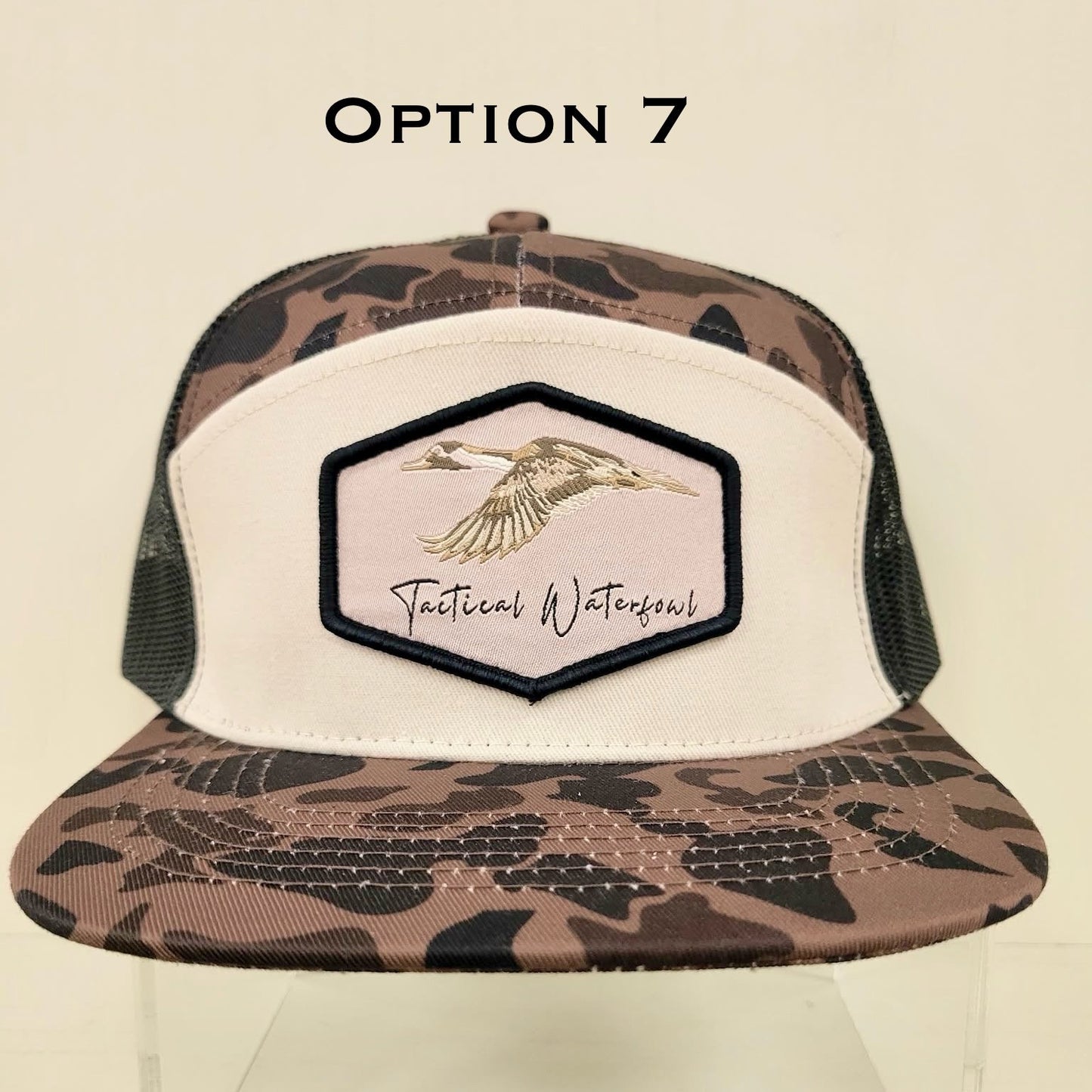 Trucker hat with camouflage pattern and brand logo on a beige background