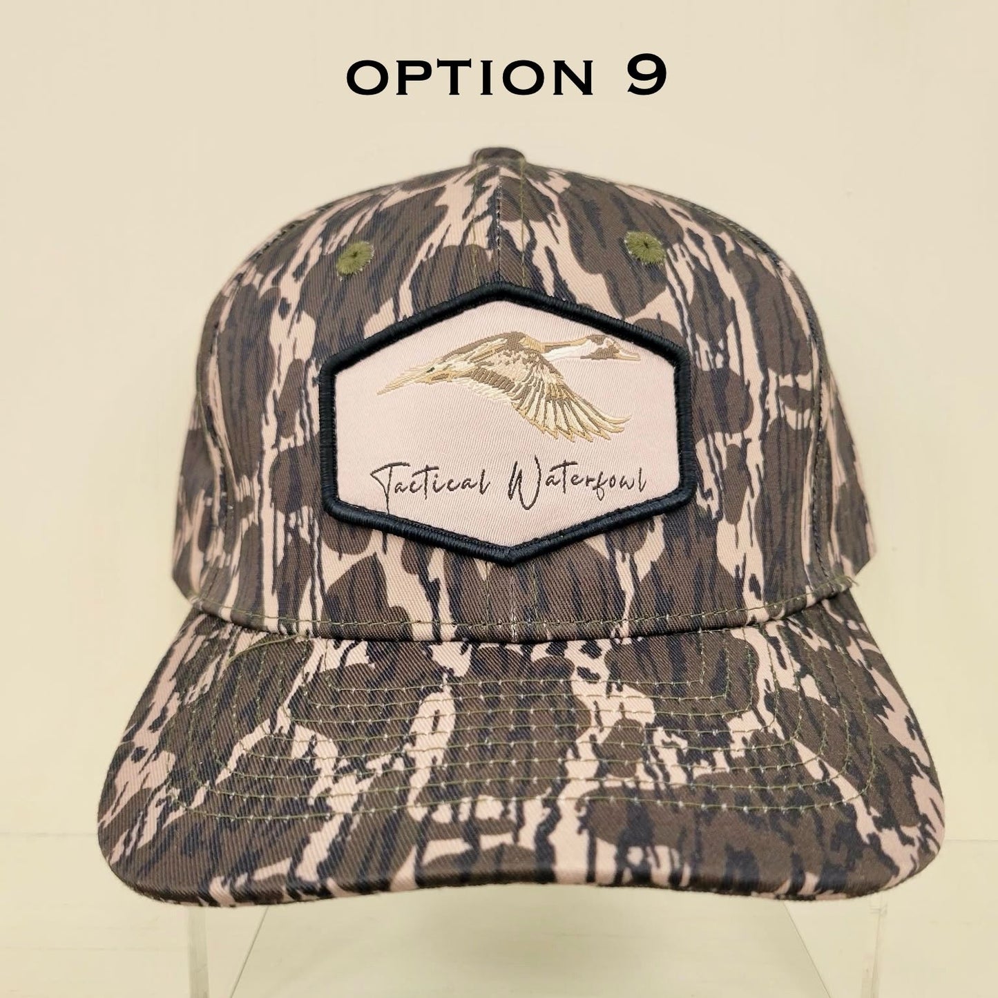 Camouflage baseball cap with a logo on a beige background