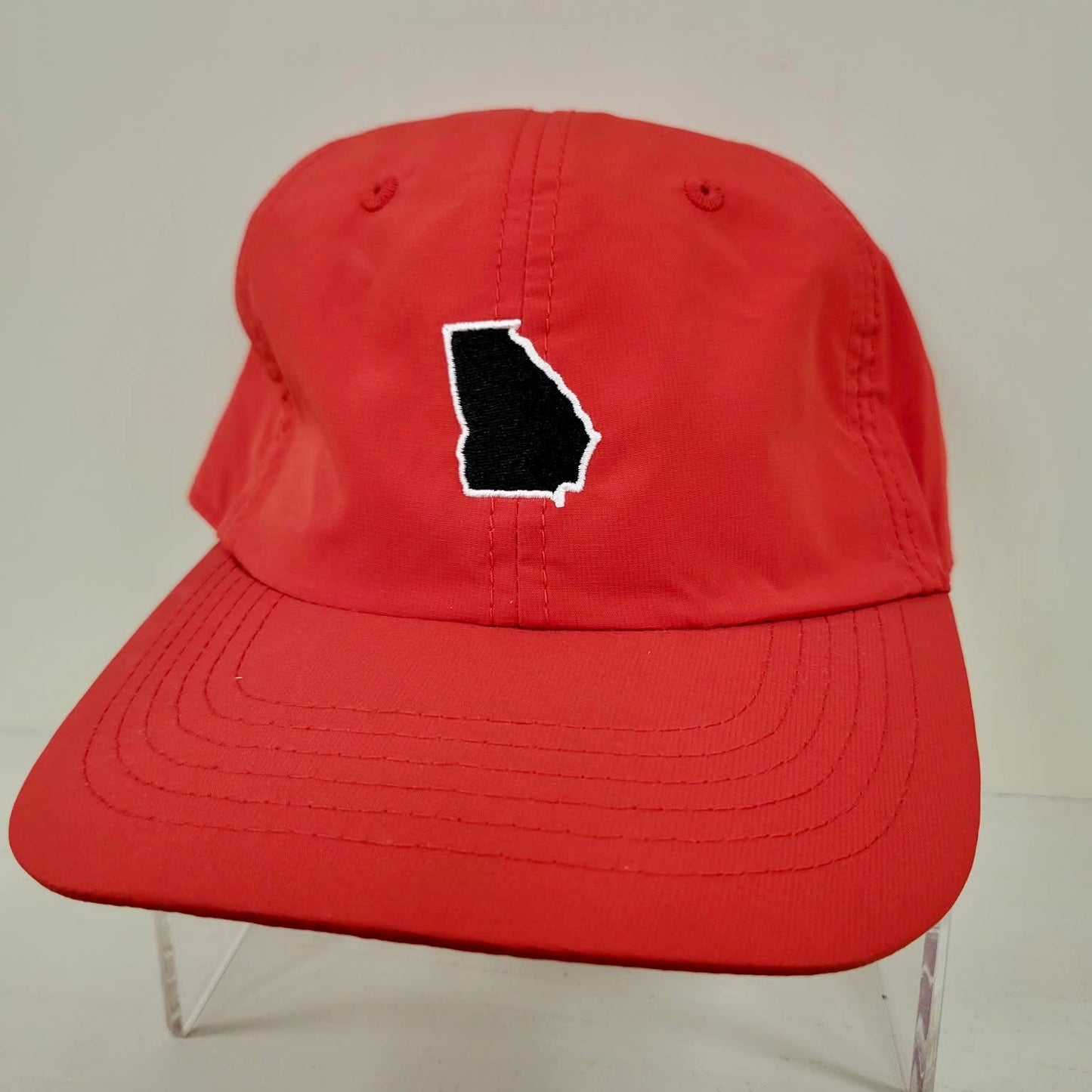 Red cap with a black outline of a state on a white background